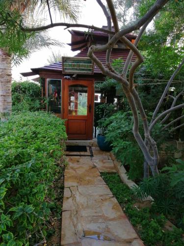 a walkway leading to a house with a tree at Lazib Inn Resort & Spa in Tunis