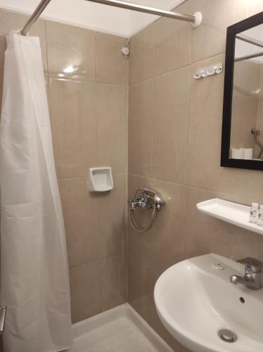 a bathroom with a shower and a sink at Saint George Hotel in Loutra Edipsou