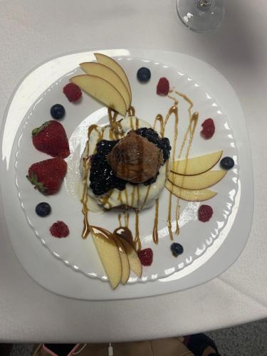 a plate of food with fruit and bananas on a table at Lacul de argint in Gura Rîului