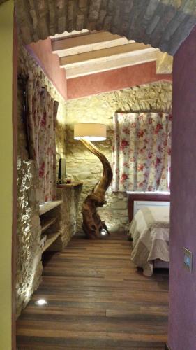 a bedroom with a tree in the middle of the room at Agriturismo C'era Una Volta in Camporosso