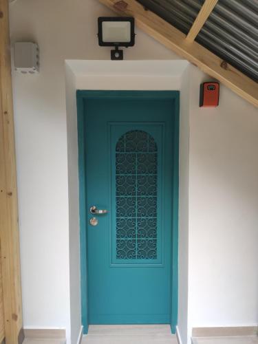 a blue door with a window on a building at Emilie Guest House in Haifa