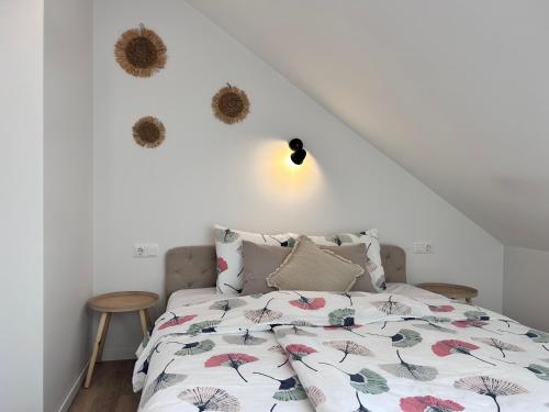 a bedroom with a bed and a white wall at Cozy and new apartment , 5km Palanga to the center. in Vydmantai