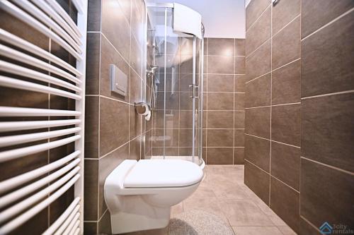 a bathroom with a toilet and a shower at Saltic Deluxe Apartment by 3City Rentals in Sopot
