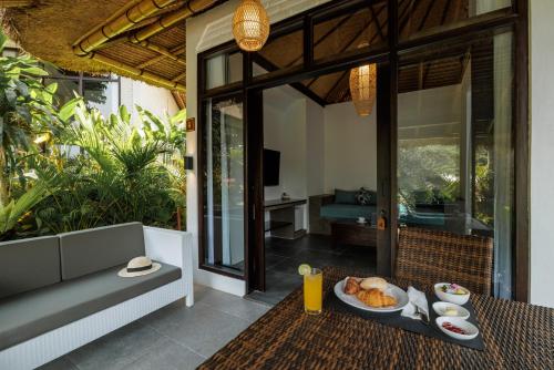 an outdoor table with a plate of food on it at Ubud Dedari Villas in Ubud