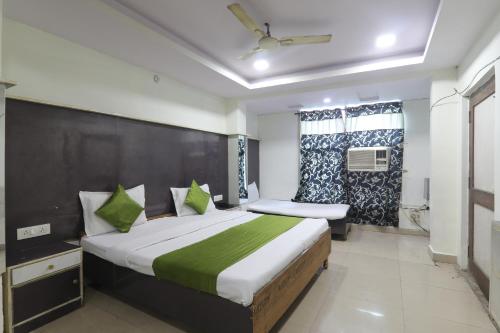 a bedroom with a large bed and a window at Hotel Dayal in Lucknow
