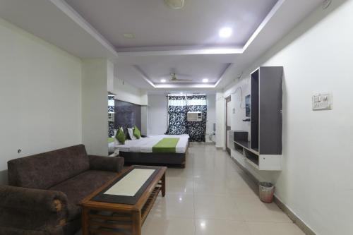 a living room with a couch and a bed at Hotel Dayal in Lucknow