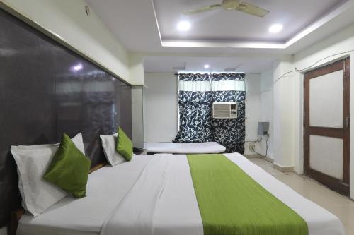 a bedroom with a large bed in a room at Hotel Dayal in Lucknow