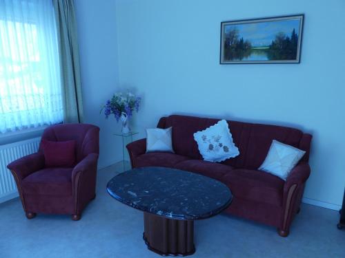 a living room with a couch and a table at Haus Kröll in Mittersill