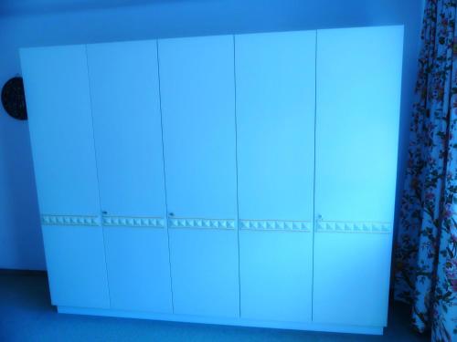 a white cabinet with a blue light on it at Haus Kröll in Mittersill