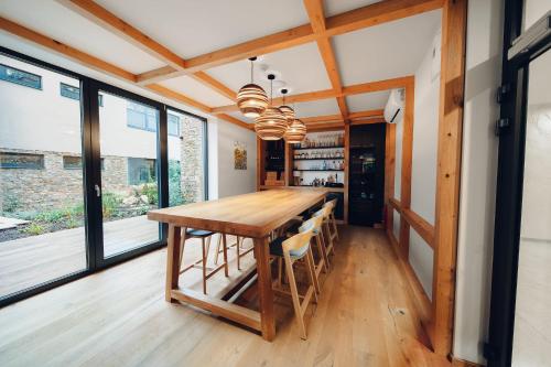 a kitchen with a wooden table and some windows at Vista Resort & Club in Prague