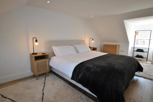 a bedroom with a bed with a black blanket on it at Crows Neuk- fabulous coastal family home in Saint Monance