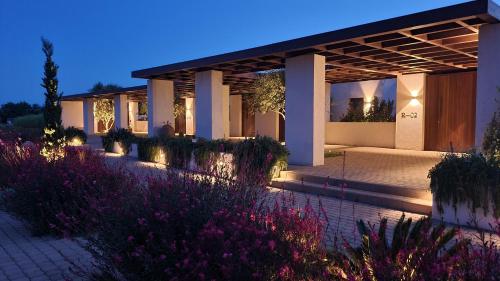 a house with a garden in front of it at night at Meraviglia Slow Living in Preveza