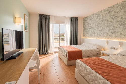 薩洛的住宿－Ponient Pirámide Salou by PortAventura World，酒店客房设有两张床和电视。