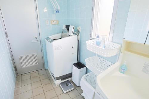 a blue bathroom with a sink and a shower at 南のヴィラ前浜 ~PCH~ #MPC in Miyako Island
