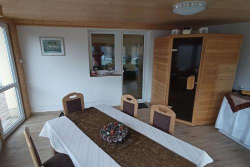 a dining room with a table and some chairs at Sunny House in Netolice