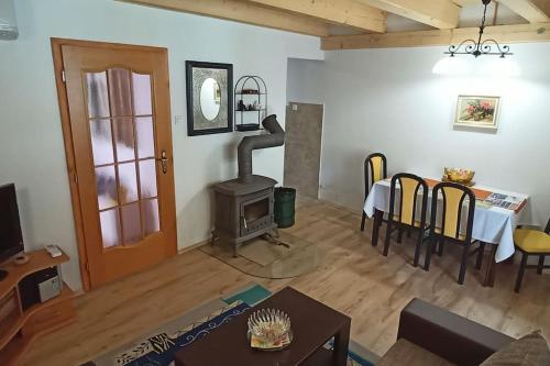 a living room with a table and a wood stove at Sunny House in Netolice