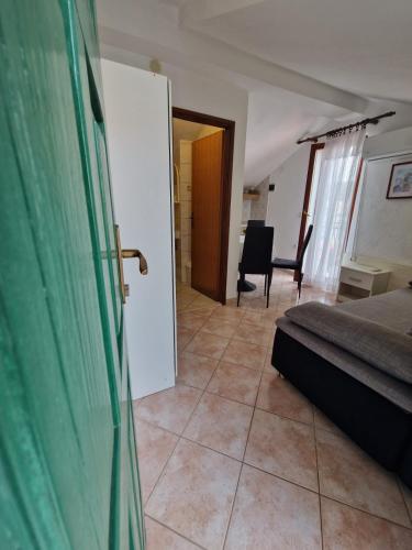 a bedroom with a bed and a living room at Old town - AP3 in Tribunj