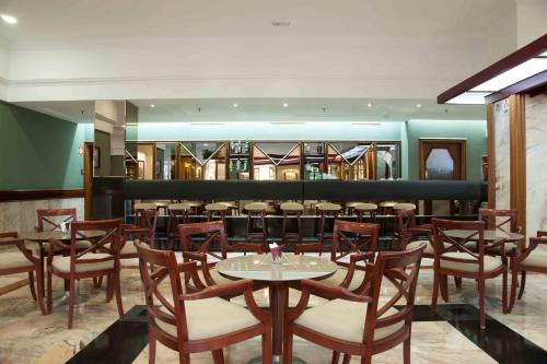 a restaurant with tables and chairs and a bar at Hotel Principe Paz in Santa Cruz de Tenerife