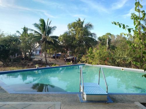 a swimming pool with a chair in a resort at Heart of Mother Earth (HOME) Resort in Aringay
