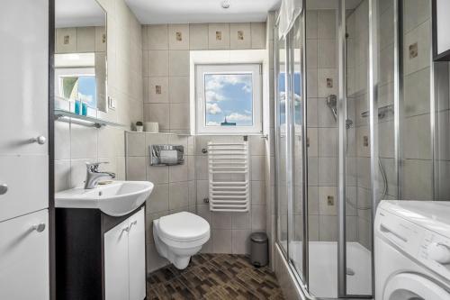 a bathroom with a toilet sink and a shower at Metro Dworzec Gdański Standard Studio in Warsaw