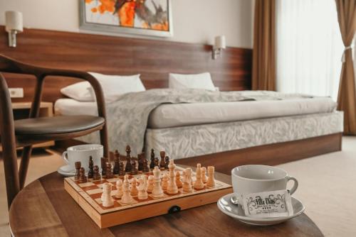 a room with a chess board and cups on a table at Boutique Hotel Ukus in Tešanj