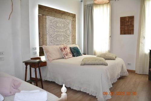 a bedroom with a white bed with pillows on it at TENUTA BORGATO MORELLI in Este