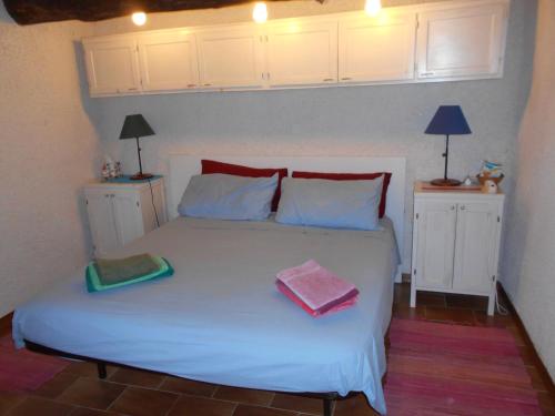 a bedroom with a white bed with two towels on it at Appartamento Iesa in Lama
