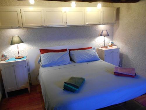 a bedroom with a white bed with two pillows and two lamps at Appartamento Iesa in Lama