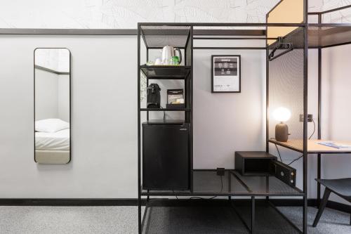 a loft bed with a mirror and a desk at Stay Swanky Bed & Breakfast in Zagreb