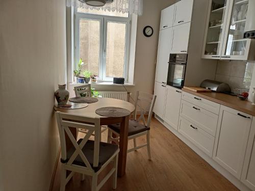 a kitchen with a table and chairs in a room at -WYPOCZYNKOWY- in Sopot