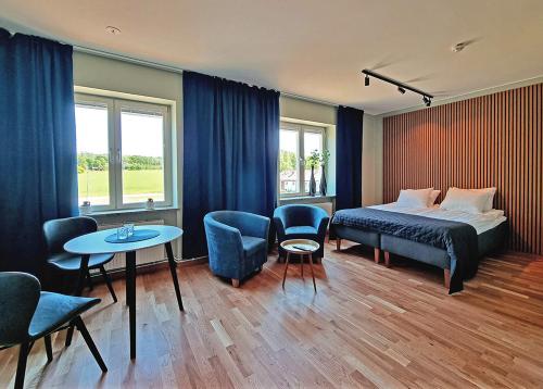 a bedroom with a bed and a table and chairs at Sankt Anna Resort in Sankt Anna