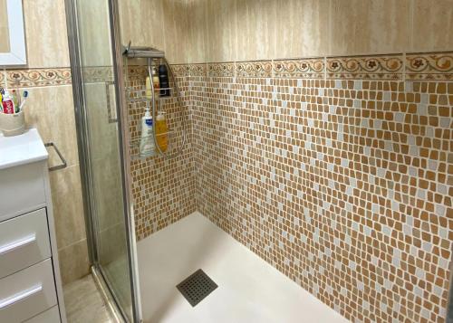 a bathroom with a shower with brown tile at Cozy apartment Benidorm Poniente 5 min from the beach in Benidorm