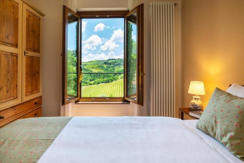 1 dormitorio con cama y ventana con vistas en TORREVISTA - Opened 2022, en Montaione