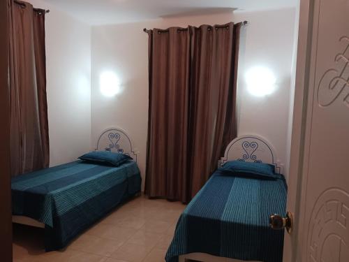 Ένα ή περισσότερα κρεβάτια σε δωμάτιο στο Appartement Fethia