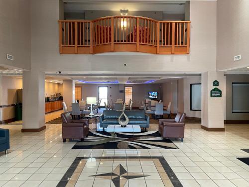 a lobby of a hotel with couches and chairs at Wingate by Wyndham Augusta Fort Eisenhower in Augusta