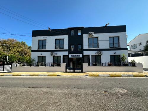 a black and white building on the side of the street at Ozbilge Apartments in Kyrenia