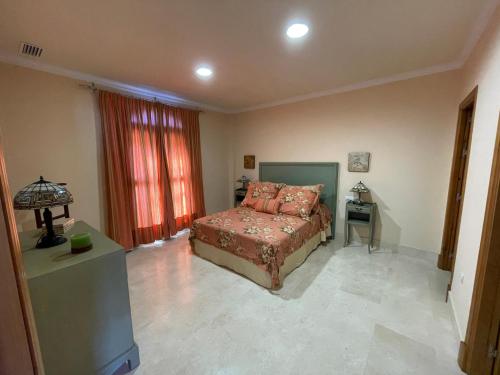 a bedroom with a bed and a table with a lamp at VILLA en Playa La Barrosa in Chiclana de la Frontera