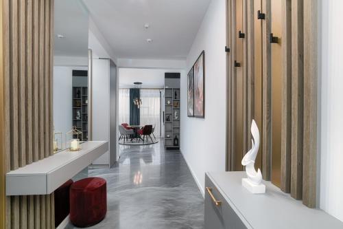 a hallway with a living room and a dining room at Peninsula Luxury & Spa in Năvodari