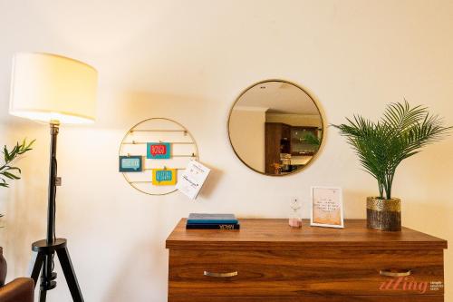 a room with a dresser with a mirror and a lamp at A pretty holiday home in Malta’s fishing village in Marsaxlokk