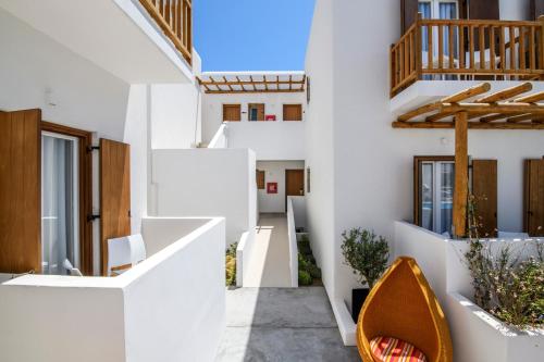 a view of the hallway of a house with white walls at Mykonaki Hotel in Ano Mera