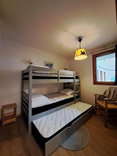 Ce lit se trouve dans un dortoir doté de 2 lits superposés et d'une lampe. dans l'établissement Appartement Orcières Merlette, à Orcières