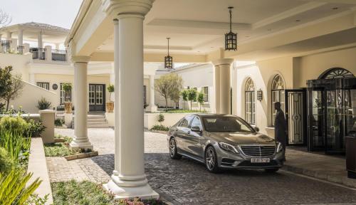 a car parked in front of a house at Four Seasons Hotel The Westcliff in Johannesburg