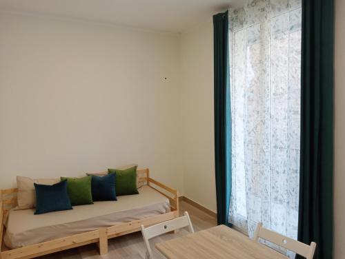 a room with a bed and a window with a couch at Butterfly Apartments in Palermo