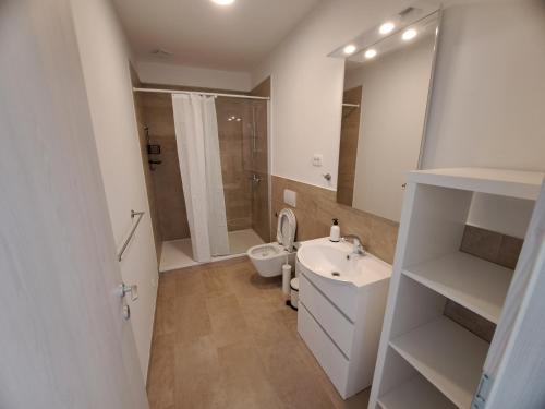 a bathroom with a toilet and a sink and a mirror at Apartments Pronavtik in Piran