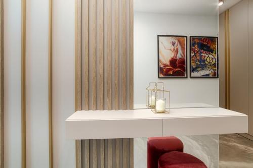 a room with a white shelf and a red chair at Peninsula Luxury & Spa in Năvodari