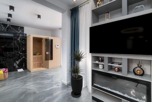 a living room with a large flat screen tv at Peninsula Luxury & Spa in Năvodari