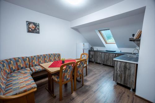 a living room with a couch and a table at Pensiunea Flora in Băile Tuşnad