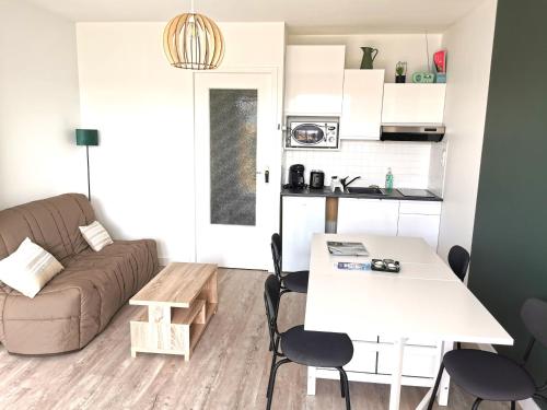 un salon avec un canapé et une table dans l'établissement Le Ptit Chaumois - 4 personnes, à Les Sables-dʼOlonne