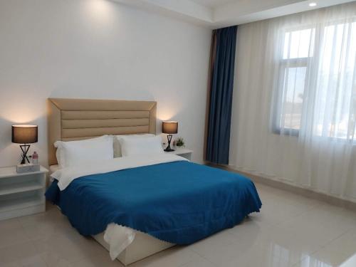 a bedroom with a large bed and a window at Dingxiangju Hotel in Chingola