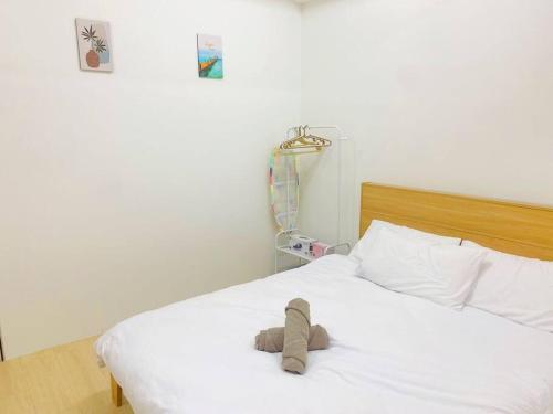 a stuffed animal is laying on a bed at S2 Muji Sunway Geo 1-8pax Sunway Medical Centre in Petaling Jaya